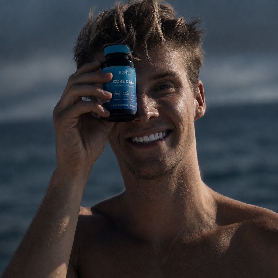 Customer holding Core Calm at the beach